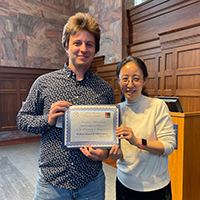 Will Manca di Villahermosa (left) at the annual Linguistics Awards Banquet receiving the award  for Excellence in the Study of Linguistics from Dr. Yun Kim.