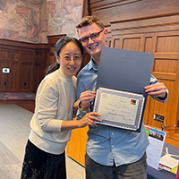 Ben Archer (right) at the annual Linguistics Awards Banquet receiving the award  for Excellence in the Study of Linguistics from Dr. Yun Kim.