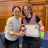 Ella Morgen (right) at the annual Linguistics Awards Banquet receiving the award  for Excellence in the Study of Linguistics from Dr. Yun Kim.